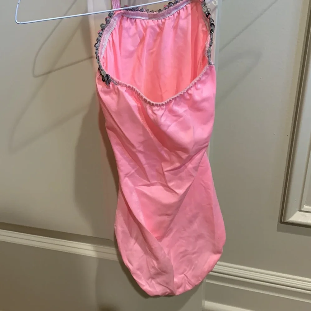 Dansco pink leotard with halter tie and trimmed in silver sequins